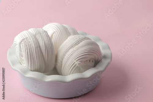 Sweet white marshmallow in a plate on a bright trendy pink background. Sweets. dessert. close-up