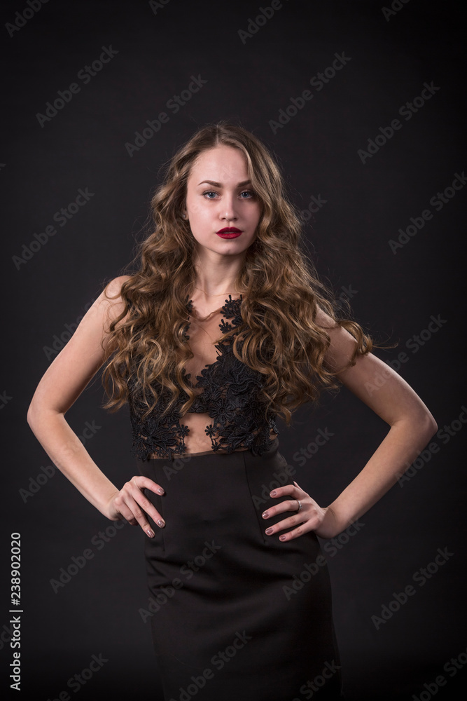 Portrait of a young girl in lace dress on a black background Portrait of a young girl in lace dress on a black background