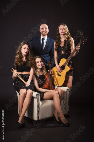 Man surrounded by beautiful girls musicians in evening lace dresses © tiplyashina
