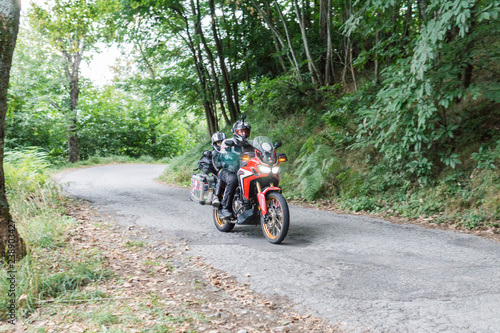 Father and son on a motorbike trip on a country road photo