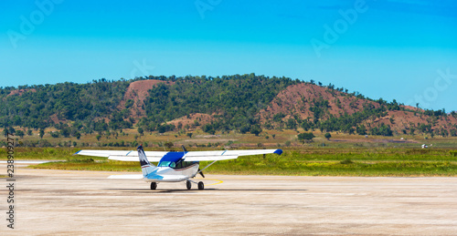 Plane at the airport on a background of mountains, Bohol island of Philippines. With selective focus.