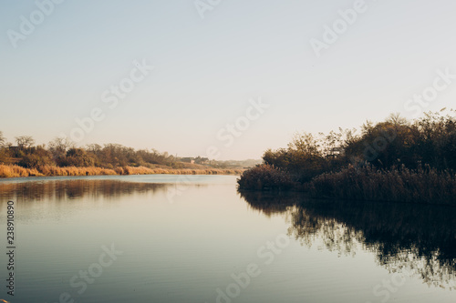 Early morning. Beautiful  colorful autumn lake in sunlight rays. Autumn background