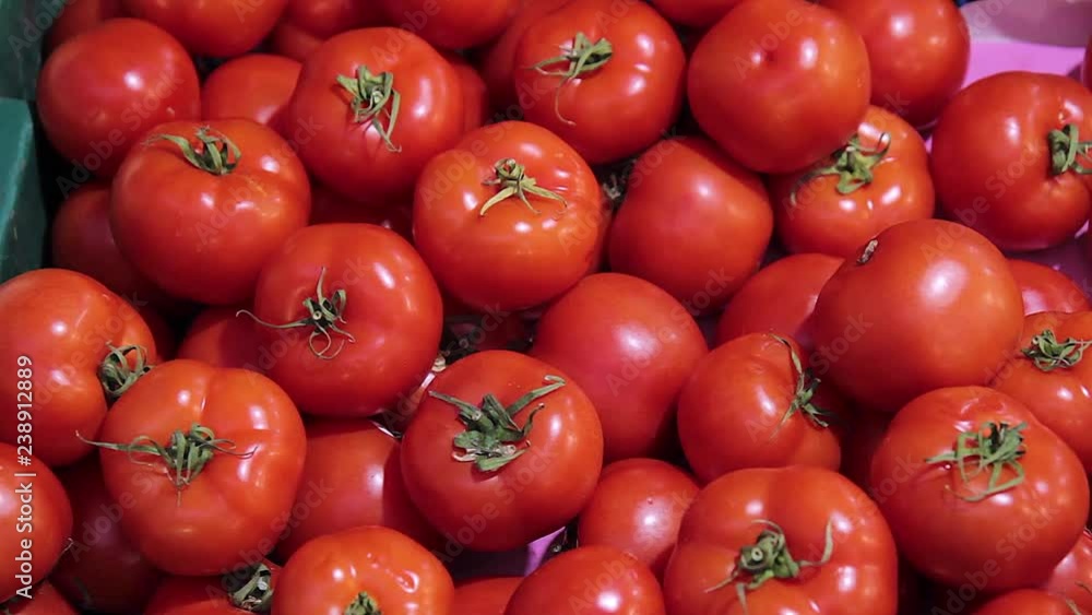 Fresh red tomatoes for sale in a market. Fresh red tomatoes for sale in a market.