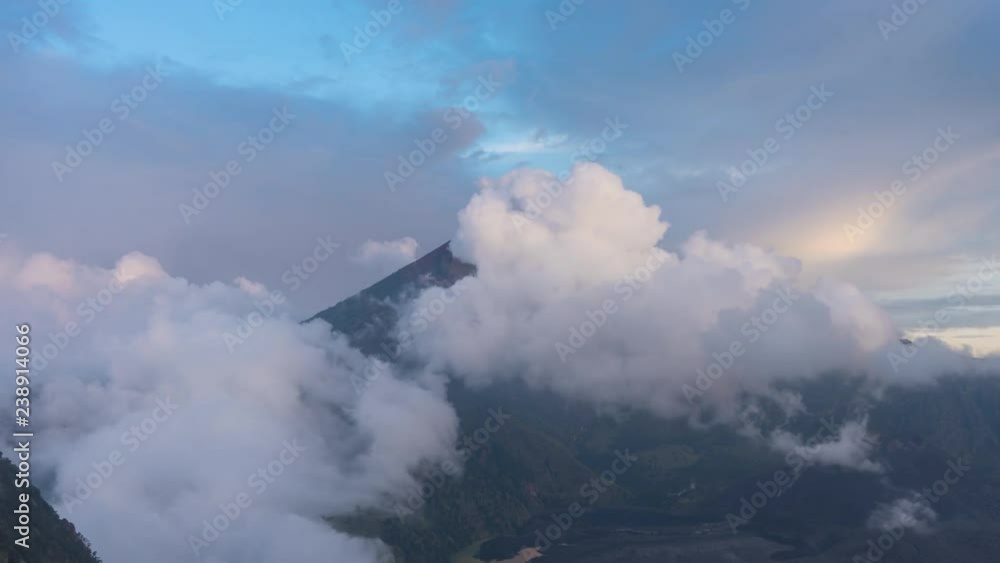 Sunset at Mount Rinjani Volcano on Lombok Indonesia 4K time-lapse. Clouds are passing by and a rainbow lights up the scenery during golden hour Sunset at Mount Rinjani Volcano on Lombok Indonesia 4K time-lapse. Clouds are passing by and a rainbow lights up the scenery during golden hour