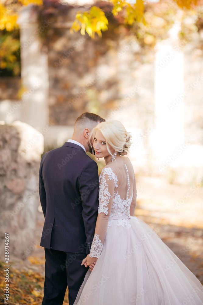 Happy bride and groom on their wedding in autumn garden Happy bride and groom on their wedding in autumn garden