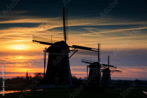 typical Dutch windmills in a row just before sunrise