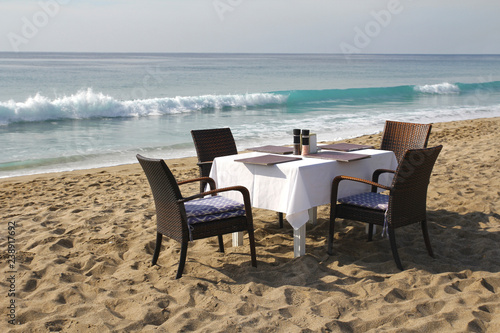 Table and chairs on the beach by the sea. Romantic concept. Marine Cafe. © Mashevur