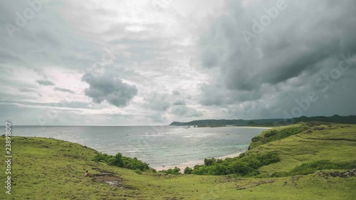 Sunset and moving clouds over the valley and beach in Kuta Lombok Indonesia in a 4K time-lapse photo