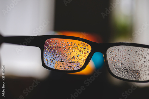 Glasses with the water drops after short walk in the rainy day photo