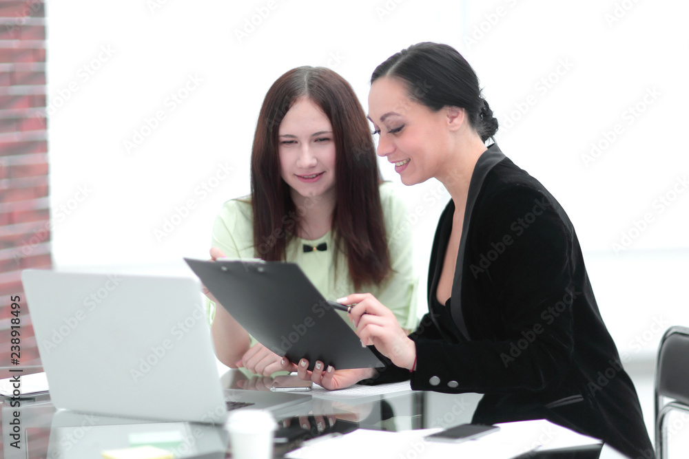 close up. business woman making notes sitting on her Desk close up. business woman making notes sitting on her Desk