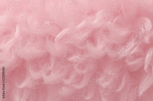 Pink animal wool texture background. Rosy tint natural wool. Close-up texture of plush fluffy fur