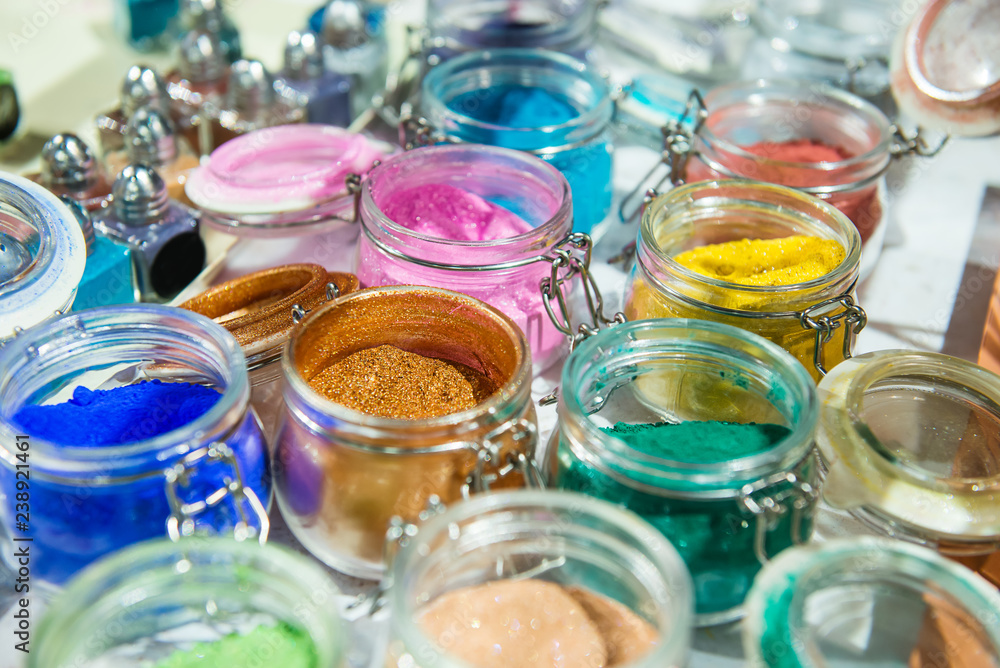 Tinsel. Shimmer. For makeup, manicure and decorating clothes. Beautiful bright background. Cosmetic, beauty products. Sparkles, confetti, glitter for decor. Multicolored eyeshadow Selective focus. Tinsel. Shimmer. For makeup, manicure and decorating clothes. Beautiful bright background. Cosmetic, beauty products. Sparkles, confetti, glitter for decor. Multicolored eyeshadow Selective focus.