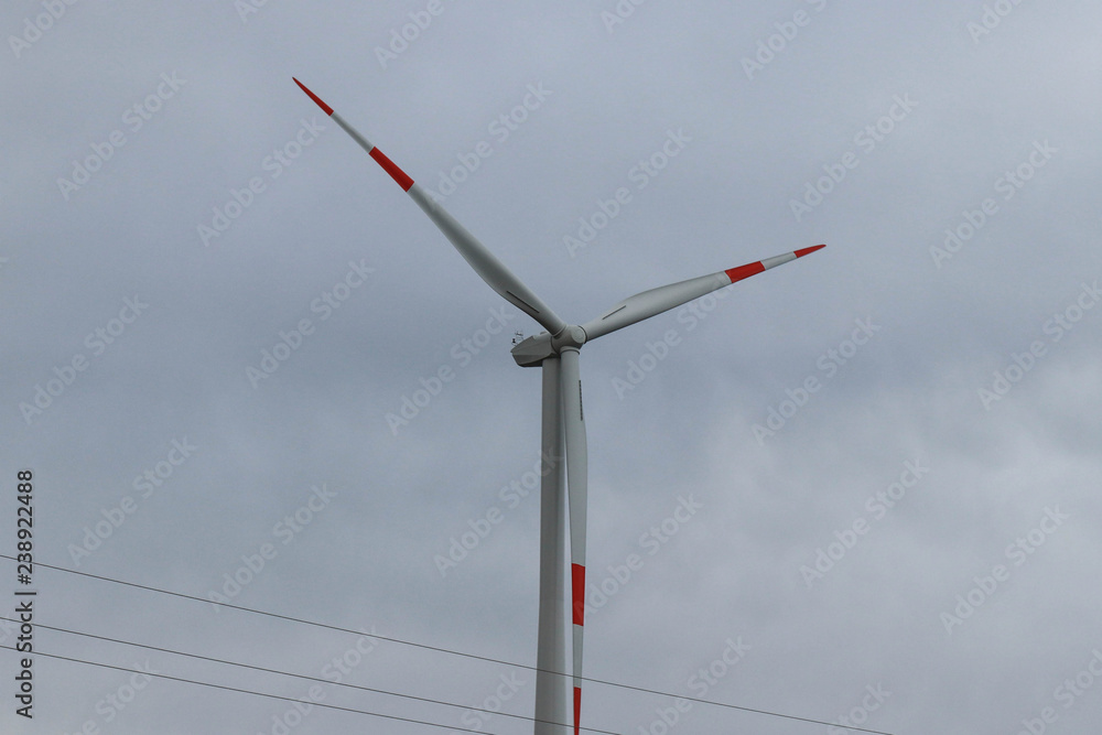 Wind farm installed in the field, cloudy day Wind farm installed in the field, cloudy day