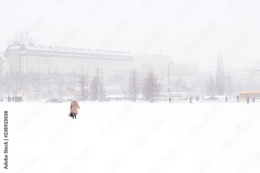 Perm, Russia - City street on a cold winter day. Everything is covered in snow. A lonely passerby.