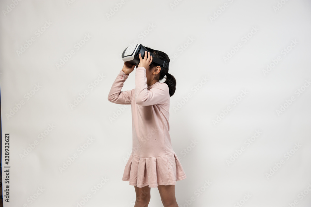A little girl playing with VR headset