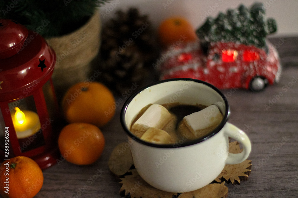 Coffee with marshmallow in a white cup on a blurred wooden background. In frame view a red lantern, mandarins. Holiday concept Coffee with marshmallow in a white cup on a blurred wooden background. In frame view a red lantern, mandarins. Holiday concept