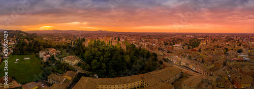 Sunset aerial panorama of Cesena in Emilia Romagna Italy near Forli and Rimini, with the medieval Malatestiana castle, Piazza del Popolo and Roman Catholic churches and cathedral on a winter afternoon