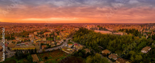 Sunset aerial panorama of Cesena in Emilia Romagna Italy near Forli and Rimini, with the medieval Malatestiana castle, Piazza del Popolo and Roman Catholic churches and cathedral on a winter afternoon photo