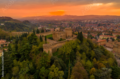 Sunset aerial panorama of Cesena in Emilia Romagna Italy near Forli and Rimini, with the medieval Malatestiana castle, Piazza del Popolo and Roman Catholic churches and cathedral on a winter afternoon photo