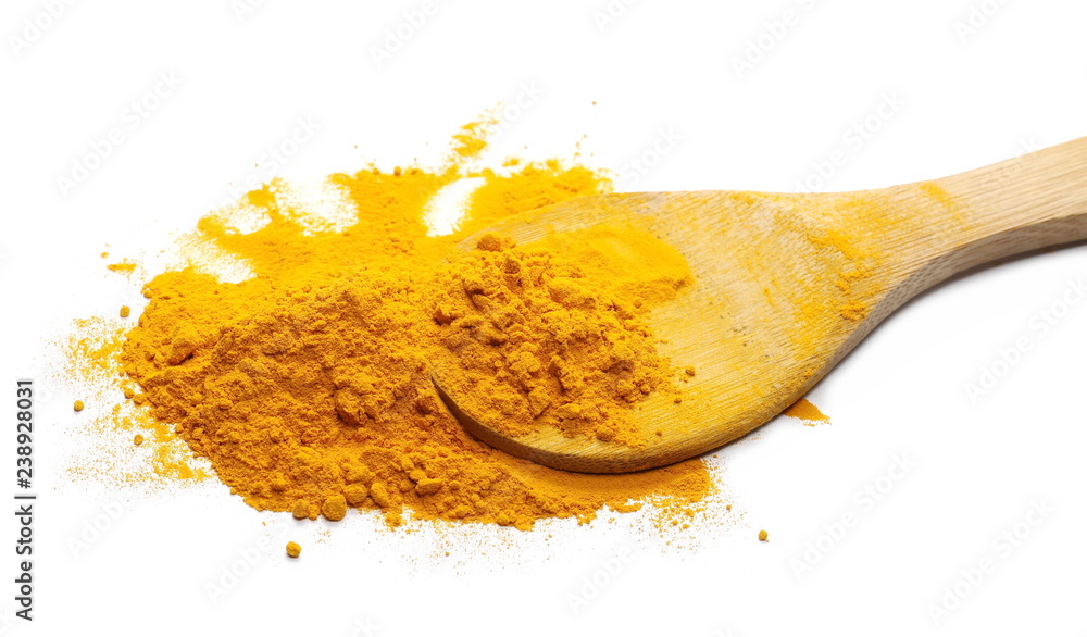 Turmeric powder pile with wooden spoon isolated on white background Turmeric powder pile with wooden spoon isolated on white background