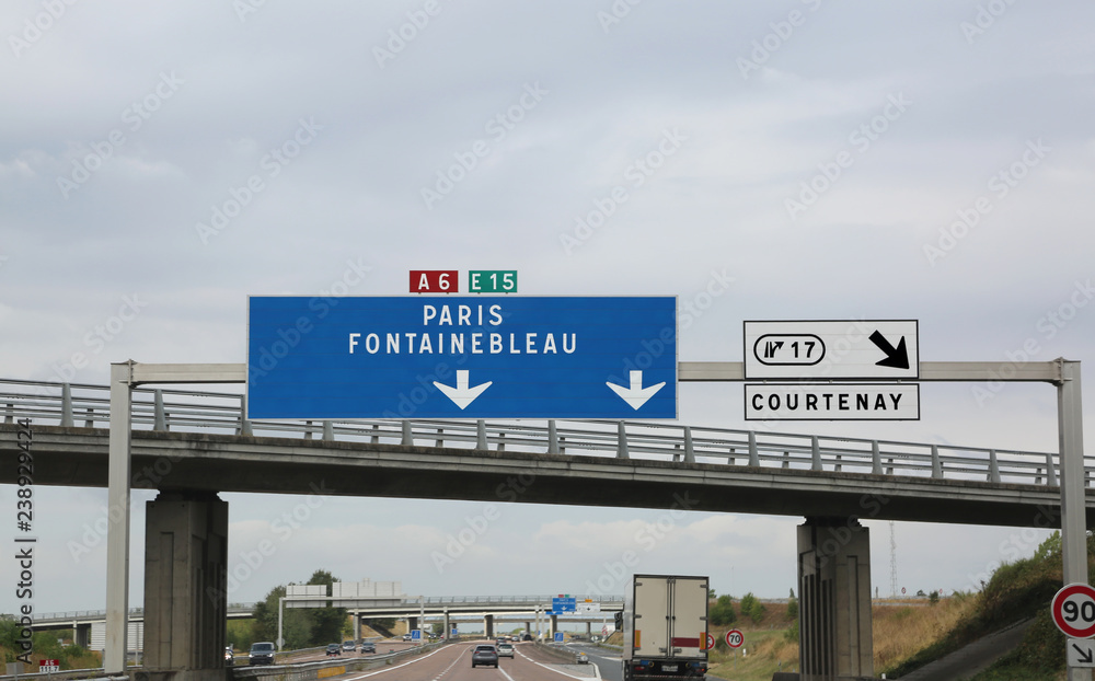 big road signs on the busy French highway to go to Paris and Fon