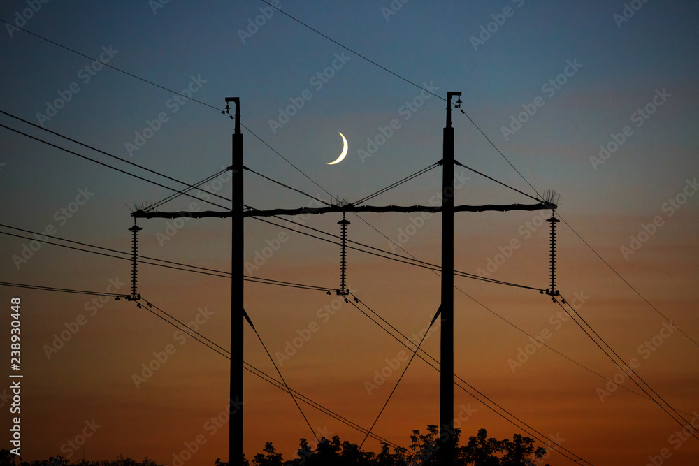 Electrical lines under a night sky with moon Electrical lines under a night sky with moon
