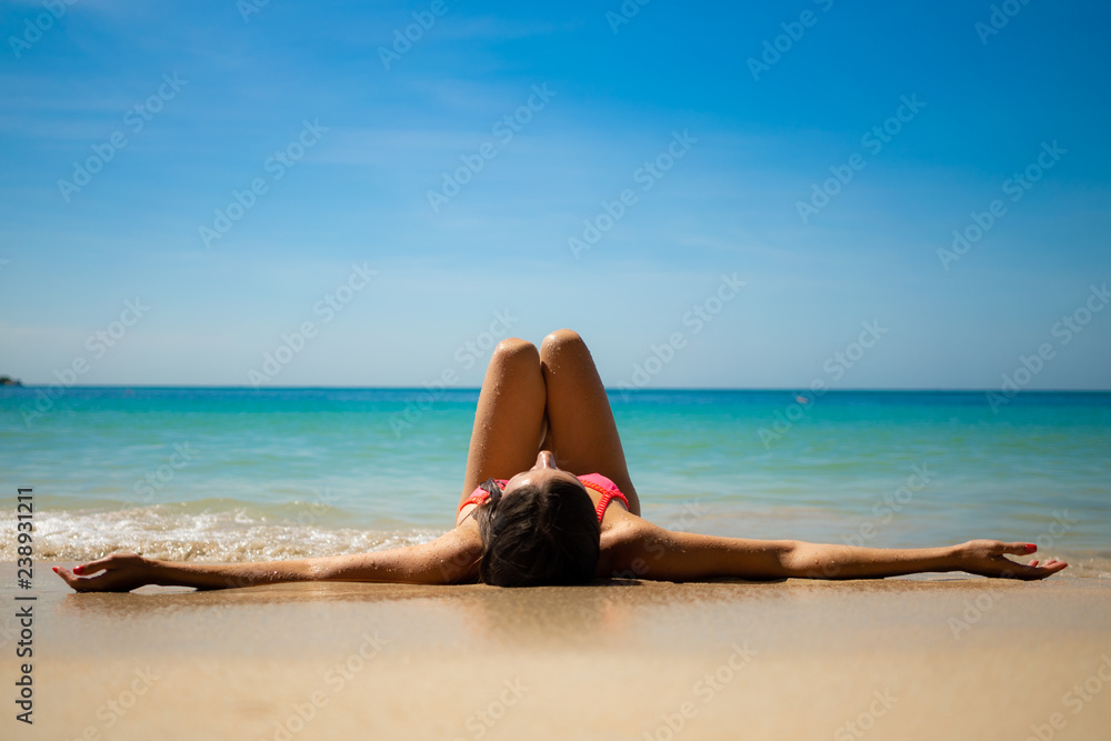 girl lying on the white beach on the blue sea girl lying on the white beach on the blue sea