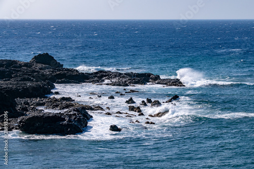Waves breaking over the edge of the lava field volcanic rocks at Puerto de Naos, La Palma, Canary Islands