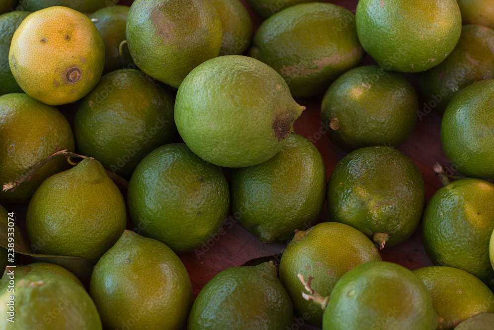 soft focus lemon green fruits on market counter background soft focus lemon green fruits on market counter background