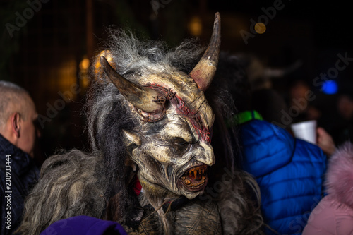 Closeup on horned devil in traditional krampuslauf with wooden masks in Retz, Austria.