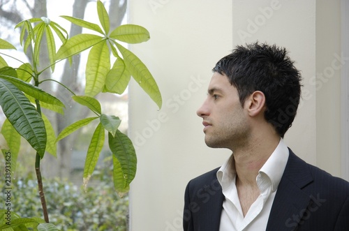 Stock photo of young businessman with green concerns. photo