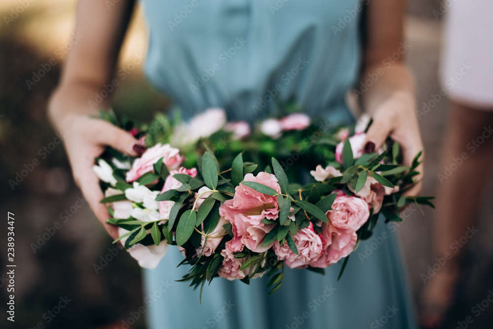 girl holding a wreath of flowers girl holding a wreath of flowers
