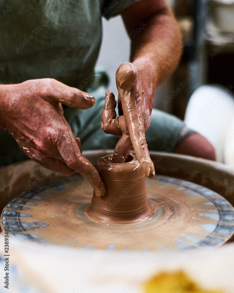 close up man working on a pottery wheel close up man working on a pottery wheel