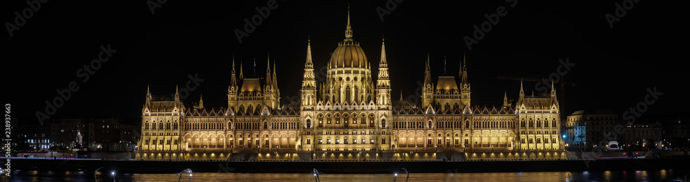 Scenic view of Hungarian parliament in ancient historic tourist city Budapest and famous river Danube in nightlight illumination in Hungary