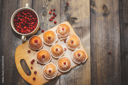 Wallpaper Mural A cup with fresh red berries. Freshly baked muffins laid out on a wooden cutting board decorated with red berries on a light wooden table peppered with sugar. Torontodigital.ca