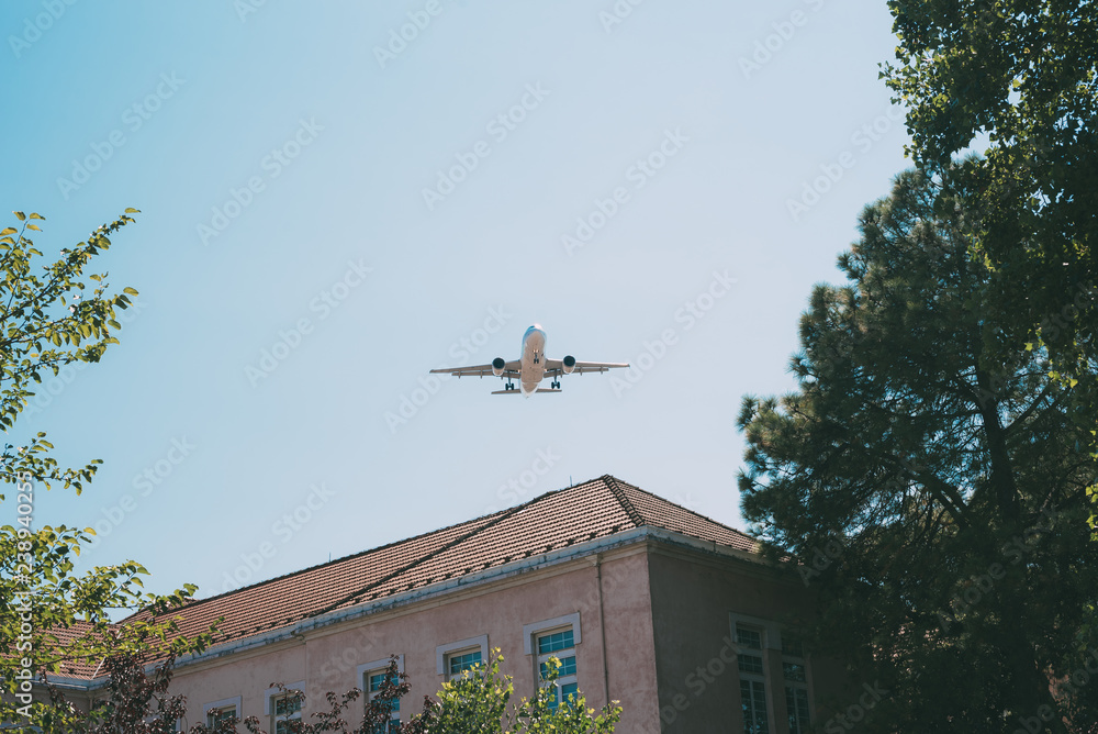 Plane flying over residential building Plane flying over residential building