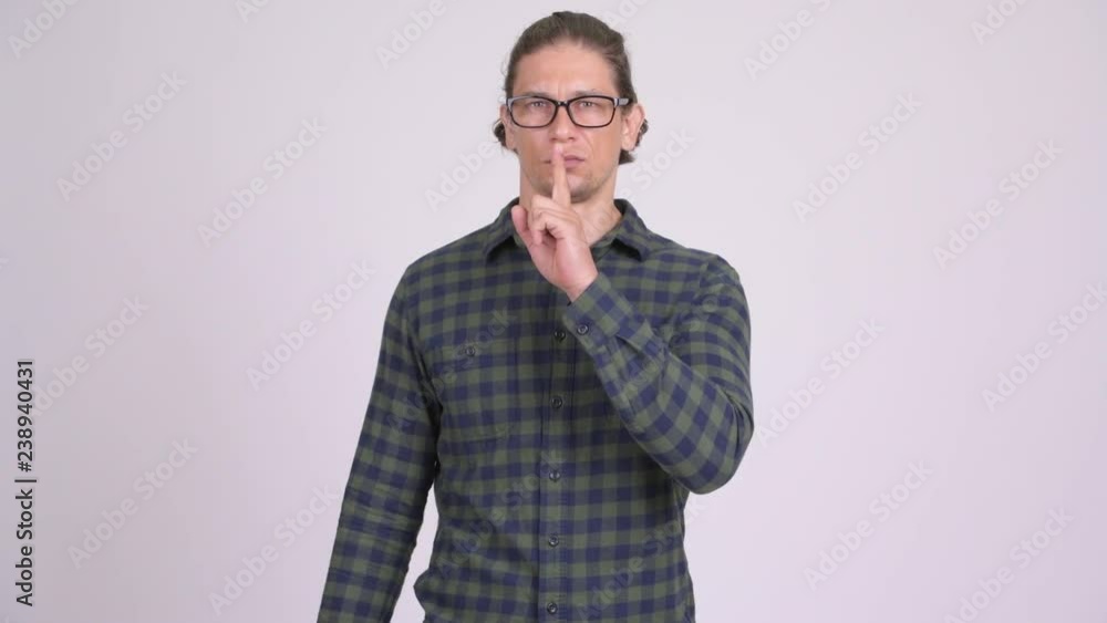 Serious hipster man with finger on lips Serious hipster man with finger on lips
