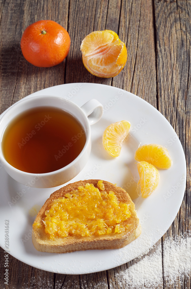 Tea and toasted bread with tangerine jam Tea and toasted bread with tangerine jam