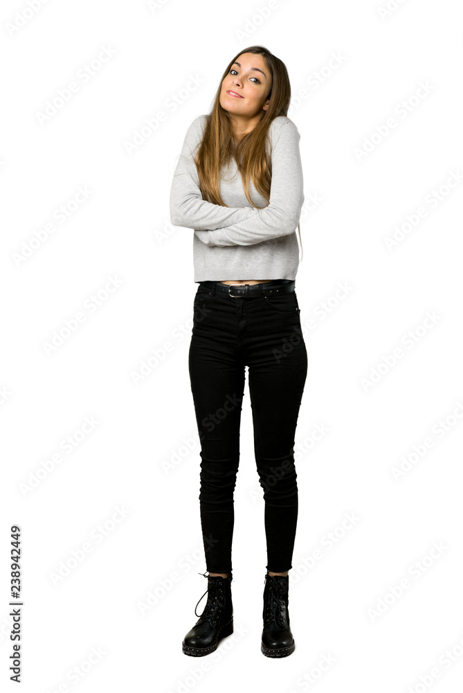 Full-length shot of young girl making doubts gesture while lifting the shoulders on isolated white background Full-length shot of young girl making doubts gesture while lifting the shoulders on isolated white background