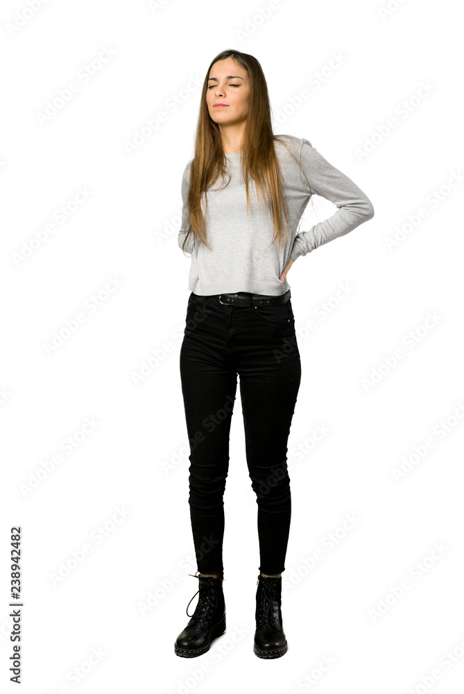 Full-length shot of young girl suffering from backache for having made an effort on isolated white background Full-length shot of young girl suffering from backache for having made an effort on isolated white background