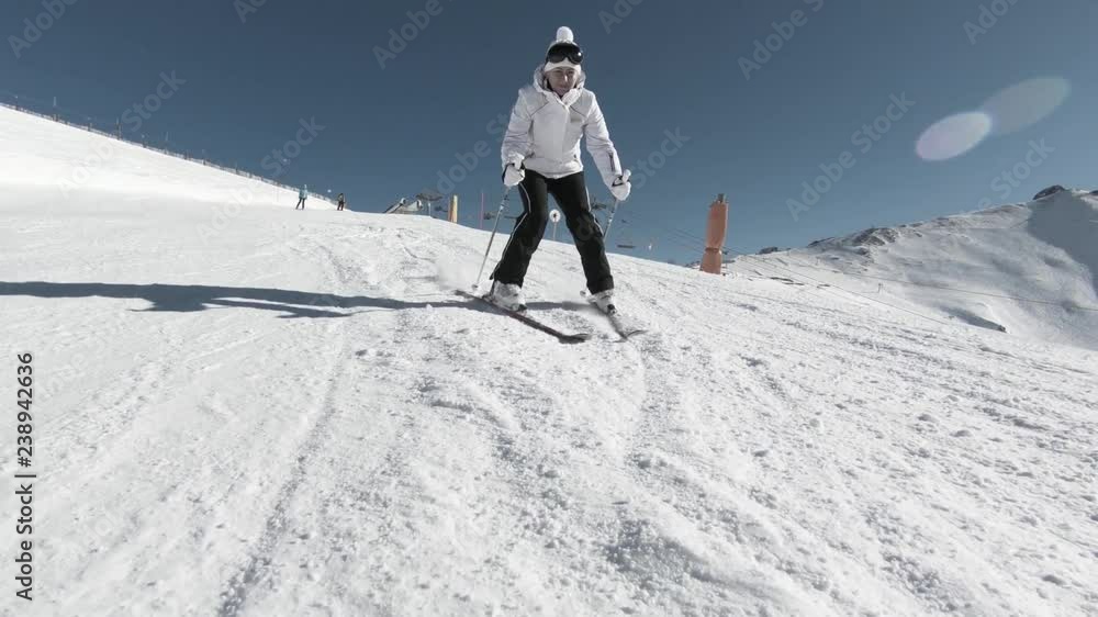 Woman skiing in the mountains at sunny day. Canillo ski region, Andorra la Vella Woman skiing in the mountains at sunny day. Canillo ski region, Andorra la Vella