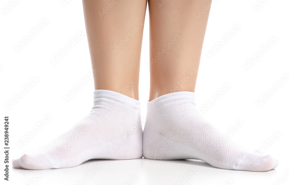 Female legs in white socks on white background. Isolation Female legs in white socks on white background. Isolation