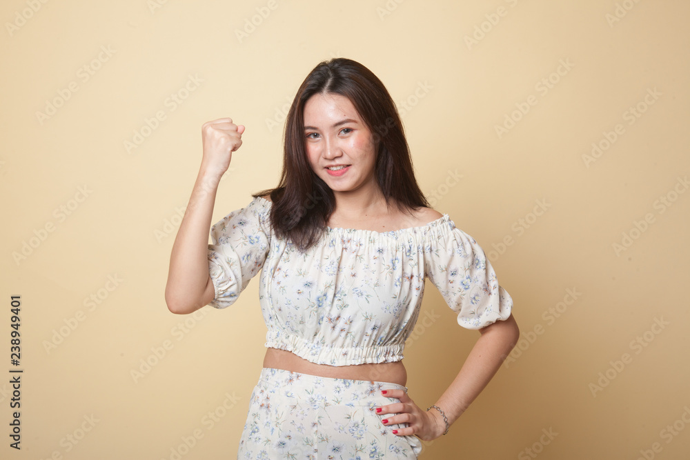 Successful young Asian woman hold fist up. Successful young Asian woman hold fist up.