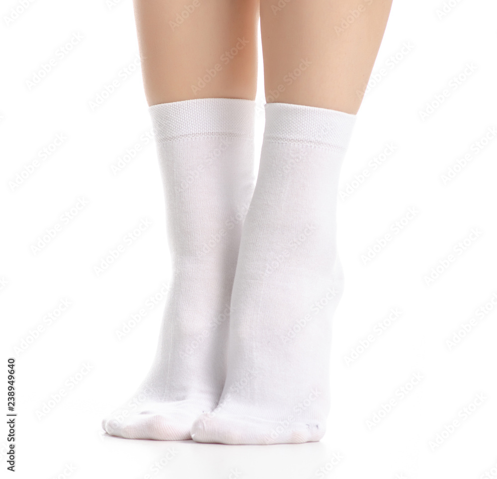 Female legs in white socks on white background. Isolation Female legs in white socks on white background. Isolation