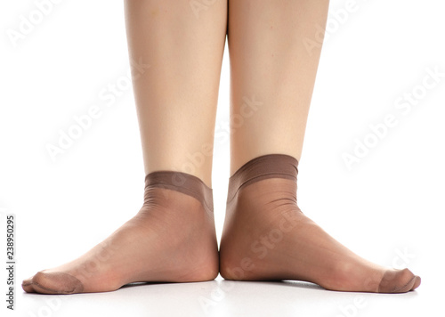 Female legs in mocha mocca nylon socks on white background. Isolation