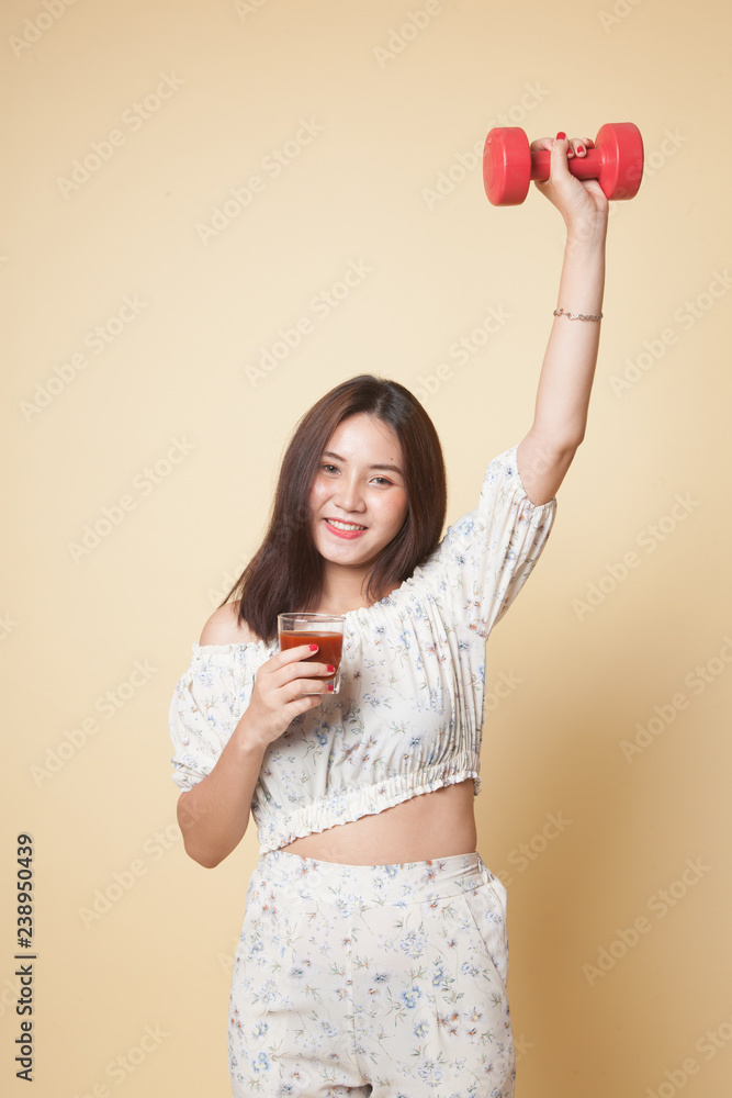 Healthy Asian woman with dumbbell and tomato juice. Healthy Asian woman with dumbbell and tomato juice.