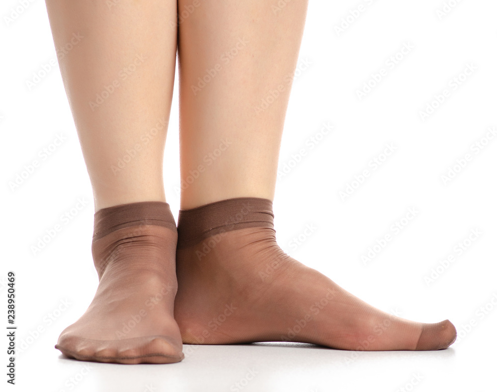 Female legs in mocha mocca nylon socks on white background. Isolation