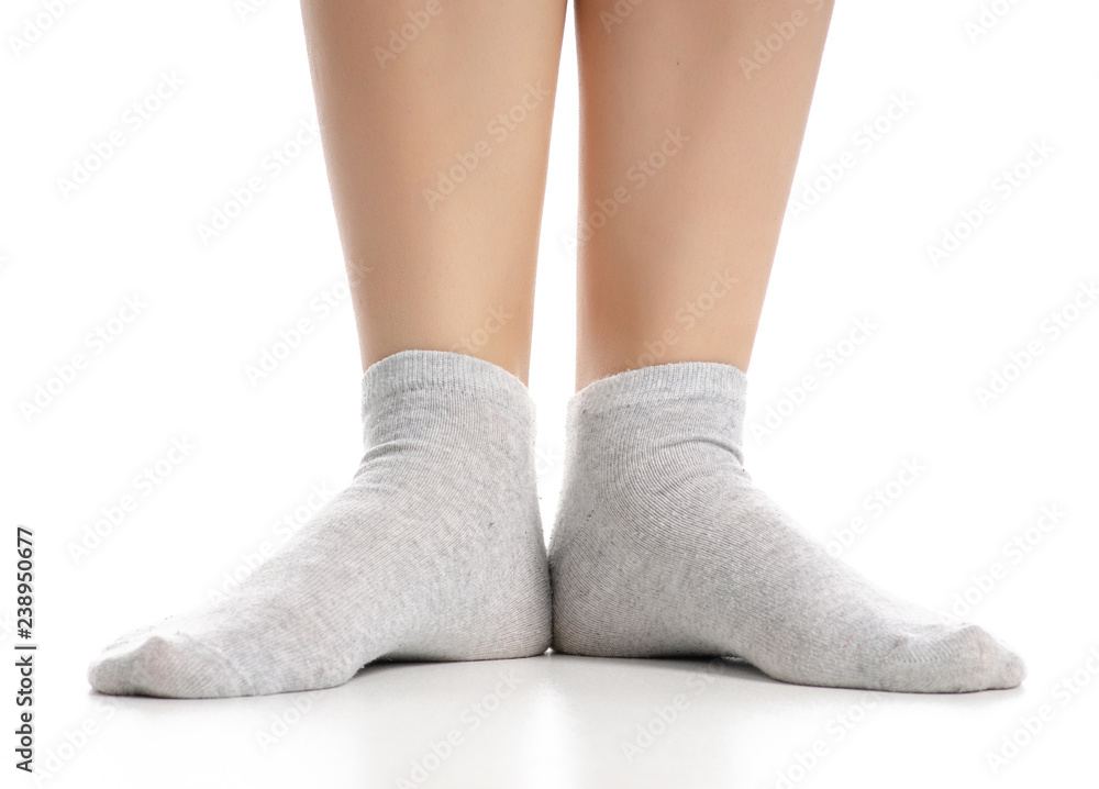 Female legs in gray socks on white background. Isolation Female legs in gray socks on white background. Isolation