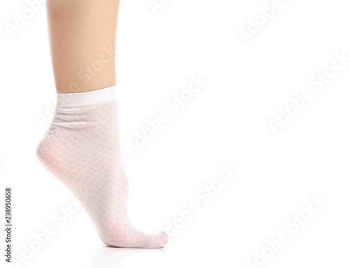Female legs in white nylon socks on white background. Isolation