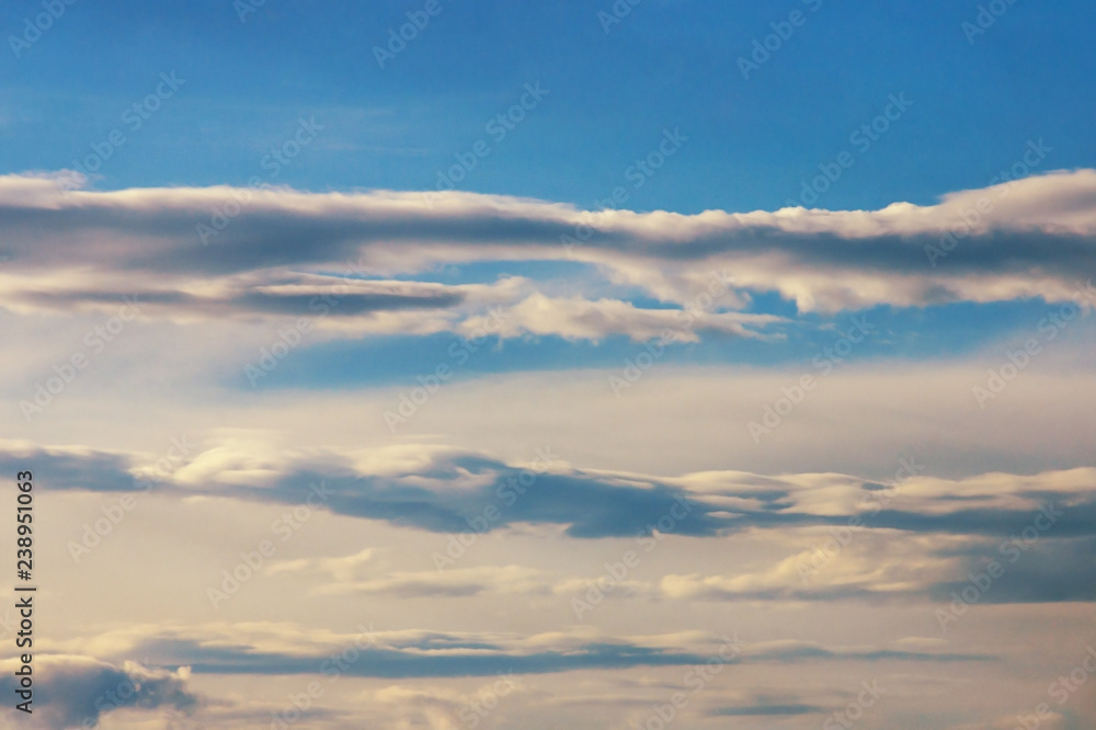 Horizontal lines of white clouds on blue sky, background Horizontal lines of white clouds on blue sky, background